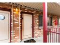 Brick building exterior with covered entryway and individual apartment access at 36 N Emerson St # 203, Denver, CO 80218