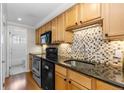 Bright kitchen with stainless steel appliances and a view into the bathroom at 36 N Emerson St # 203, Denver, CO 80218