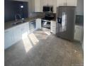 Modern kitchen featuring stainless steel appliances and granite countertops at 1240 Russell Blvd, Thornton, CO 80229
