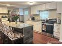 Updated kitchen features granite countertops, stainless steel appliances, and modern white cabinets at 7115 Harold St # 2, Fort Lupton, CO 80621
