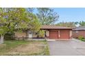 Charming brick ranch with a cozy front porch, mature trees, and attached two-car garage at 258 S 14Th Ave, Brighton, CO 80601