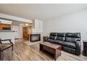 Open living room showcasing a sleek fireplace and hardwood floors at 5317 W Iliff Dr # 103, Lakewood, CO 80227