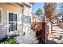 Cozy outdoor patio featuring an intimate seating area and stylish brick accents at 5317 W Iliff Dr # 103, Lakewood, CO 80227