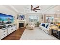 Spacious living room with large windows, fireplace, and comfortable seating area at 5029 Silver Hare Ct, Castle Rock, CO 80104