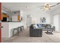 Open-concept living room with a breakfast bar, neutral paint, and comfortable seating at 4451 S Ammons St # 4-203, Littleton, CO 80123