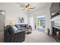 Bright living room with a cozy gray couch, coffee table and a balcony with a pleasant view at 4451 S Ammons St # 4-203, Littleton, CO 80123