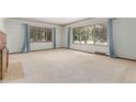 Bright living room featuring large windows, neutral paint, and a brick fireplace at 10841 Montview Blvd, Aurora, CO 80010