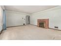 Spacious living room with a classic brick fireplace and abundant natural light at 10841 Montview Blvd, Aurora, CO 80010