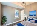 Staged bedroom with a large window, a calming color palette, and decorative accents at 1051 Chase St, Lakewood, CO 80214