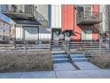 Townhome exterior with a wooden fence, concrete steps, and planters for a welcoming entrance at 1051 Chase St, Lakewood, CO 80214