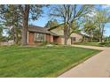 Inviting front exterior view of the home, displaying the lawn, brick and siding at 7882 S Valentia Way, Centennial, CO 80112