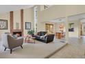 Open-concept living room with a cozy fireplace, vaulted ceilings, and stylish furnishings at 7882 S Valentia Way, Centennial, CO 80112
