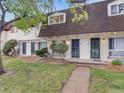 Townhome boasts a brick facade, security doors and trimmed bushes, creating curb appeal and a secure entrance at 1103 S Monaco Pkwy, Denver, CO 80224