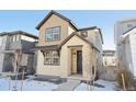 Well-maintained home featuring a stone porch and stylish, neutral-toned siding and windows at 7312 Watercress Dr, Littleton, CO 80125