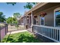 Lovely front porch with decorative flower baskets and an inviting sitting area at 2941 Glenarm Pl, Denver, CO 80205