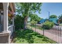 Well-maintained front yard with lush greenery and a charming wrought iron fence at 2941 Glenarm Pl, Denver, CO 80205