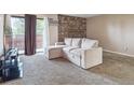 Bright living room with a modern sofa and access to a balcony at 381 S Ames St # G101, Lakewood, CO 80226