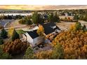 Gorgeous home with a backyard patio, a fire pit, and colorful trees at 5790 Fox Run Ct, Parker, CO 80134