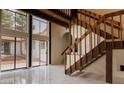 Bright foyer featuring large windows, a grand staircase, and sleek marble floors at 326 E Oak Hills Dr, Castle Rock, CO 80108
