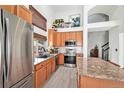 Open-concept kitchen featuring stainless steel appliances and granite countertops with seating at 15776 E 107Th Way, Commerce City, CO 80022