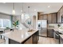Modern kitchen featuring stainless steel appliances, pendant lighting, and a center island at 2078 Wagon Wheel Aly, Brighton, CO 80601