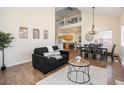 Sunlit living and dining area with hardwood floors, a vaulted ceiling, and a contemporary design at 7915 Flower St # D, Arvada, CO 80005