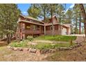 Charming two-story home with a front porch and well-manicured landscaping and a beautiful setting at 35731 Elkridge Run, Elizabeth, CO 80107