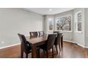 Dining room featuring hardwood floors, large windows, and a six-chair dining set at 6041 S Salida Ct, Aurora, CO 80016