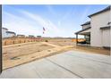 New home backyard featuring a patio area, mountain views, and unfinished landscaping at 16618 W 92Nd Pl, Arvada, CO 80007