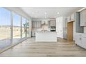 Modern kitchen with stainless steel appliances, gray cabinets, and island with breakfast bar at 16618 W 92Nd Pl, Arvada, CO 80007