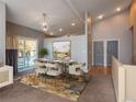 Bright dining area with modern chandelier, sliding door to the exterior, and a stylish rug at 9025 W 79Th Way # D, Arvada, CO 80005