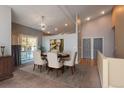 The dining room is bright with a large table, decorative chandelier, and sliding glass door at 9025 W 79Th Way # D, Arvada, CO 80005
