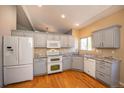 Well-lit kitchen featuring grey cabinets, granite countertops, and stainless steel appliances at 9025 W 79Th Way # D, Arvada, CO 80005
