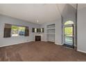 Bright living room with a cozy fireplace, built-in shelves, and abundant natural light at 9025 W 79Th Way # D, Arvada, CO 80005