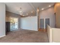 Spacious carpeted living area featuring a ceiling fan and sliding glass doors to the outside at 9025 W 79Th Way # D, Arvada, CO 80005