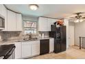 Bright kitchen featuring white cabinets, granite countertops, and stainless steel appliances at 12434 E Alaska Ave, Aurora, CO 80012