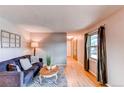 Relaxing living room featuring hardwood floors, a comfortable sofa, and neutral paint at 10109 W Fremont Ave, Littleton, CO 80127