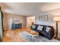 Cozy living room featuring hardwood floors, a comfortable sofa, and stylish decor at 10109 W Fremont Ave, Littleton, CO 80127