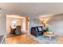 Open-concept living and dining area featuring hardwood floors and comfortable furnishings at 10109 W Fremont Ave, Littleton, CO 80127