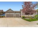 Home exterior showcasing the two-car garage, well-maintained lawn, and attractive curb appeal at 2716 Dundee Pl, Erie, CO 80516
