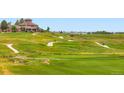 Picturesque golf course view featuring undulating greens, winding cart paths and clubhouse in the distance at 2716 Dundee Pl, Erie, CO 80516