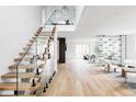 Bright entryway boasts an open staircase with glass railings and views into the spacious living area at 1518 S Columbine St, Denver, CO 80210