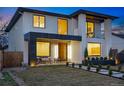 Modern home featuring expansive windows, inviting entrance and meticulously maintained lawn at 1518 S Columbine St, Denver, CO 80210
