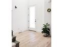 Bright and airy entryway with light hardwood floors at 6202 N Galena St, Denver, CO 80238