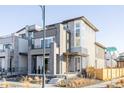 Modern three-story home with gray siding and a sleek design at 6202 N Galena St, Denver, CO 80238