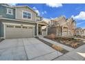 Two-story home featuring an attached two-car garage and quaint front porch at 17420 E 95Th Ave, Commerce City, CO 80022