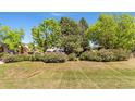 Image of a lush lawn surrounded by bushes and mature trees providing privacy and a peaceful setting at 4390 S Sheridan Blvd, Littleton, CO 80123