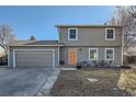 Charming two-story home featuring an attached garage and a well-manicured front yard at 114 Walnut Dr, Frederick, CO 80530