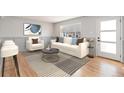 Bright living room featuring modern decor, wood floors, and a comfortable seating arrangement at 1932 S Michigan Way, Denver, CO 80219
