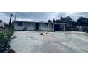 This single-story home features a large concrete yard, covered parking, and a charming front porch with white railings at 481 Cragmore St, Denver, CO 80221